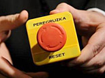 An assistant shows the button Secretary of State Hillary Clinton handed to Russian Foreign Minister Sergei Lavrov (AFP/Fabrice Coffrini)