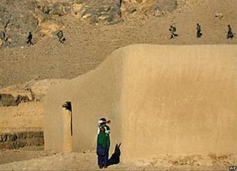 Афганская девочка наблюдает за канадскими военными, патрулирующими местность в провинции Кандагар