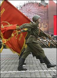 Soldiers in Soviet period uniforms march towards Red Square