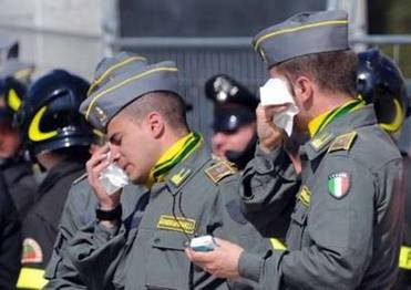 Italian Guardia di finanza (Fiscal Police) personnel react as ...