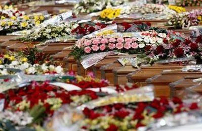 The coffins of the victims are seen during the state funeral ...